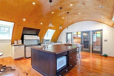 Originally a Quonset hut, this unique lakefront property blends - photo 7