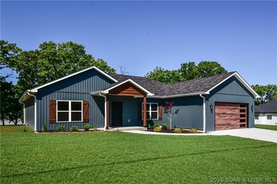 BRAND NEW HOME in the HEART of Osage Beach!! This striking home - photo 1