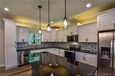 BRAND NEW HOME in the HEART of Osage Beach!! This striking home - photo 6