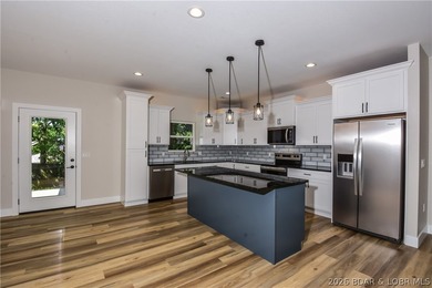 BRAND NEW HOME in the HEART of Osage Beach!! This striking home - photo 7
