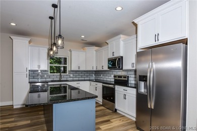 BRAND NEW HOME in the HEART of Osage Beach!! This striking home - photo 8