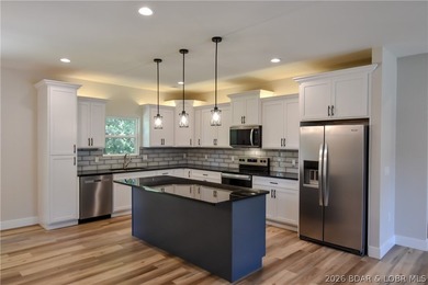 BRAND NEW HOME in the HEART of Osage Beach!! This striking home - photo 10