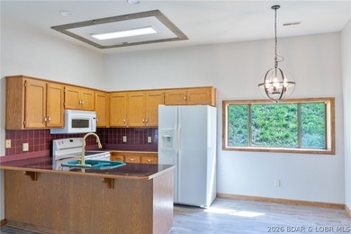 Welcome to this 3-bedroom, 2-bathroom home in Sunrise Beach, MO - photo 2