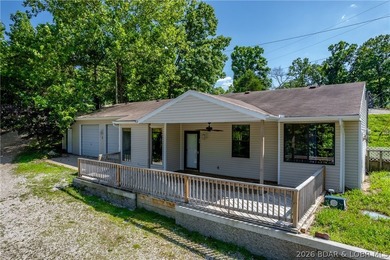 Welcome to this 3-bedroom, 2-bathroom home in Sunrise Beach, MO - photo 3