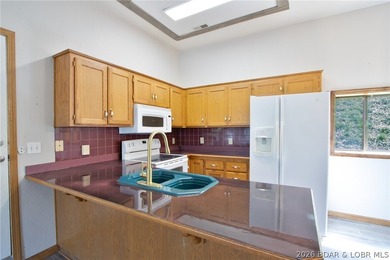 Welcome to this 3-bedroom, 2-bathroom home in Sunrise Beach, MO - photo 7