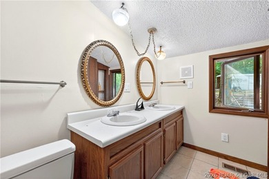 Tucked away on 2.33 lakefront acres, 33400 Kings Way Road offers - photo 7
