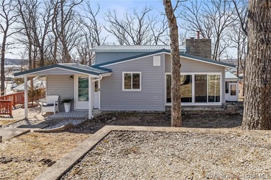 Newer metal roof, gutters & downspouts, newer vinyl siding - photo 3