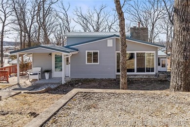 Newer metal roof, gutters & downspouts, newer vinyl siding - photo 3
