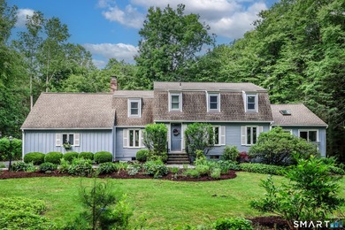 Nestled on a private, beautifully landscaped lot in the highly - photo 1