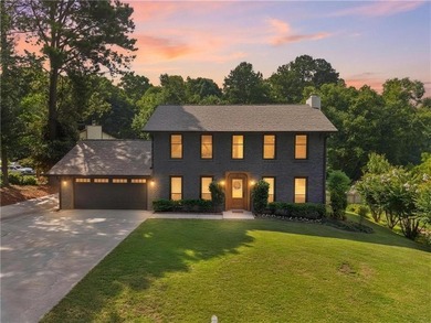 Tucked into a private wooded lot with a stunning lake view in - photo 1
