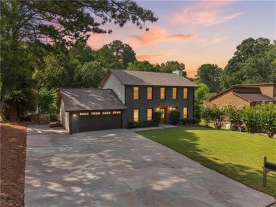 Tucked into a private wooded lot with a stunning lake view in - photo 2