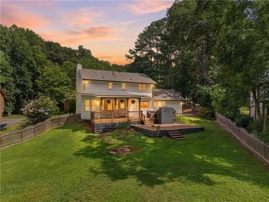 Tucked into a private wooded lot with a stunning lake view in - photo 3