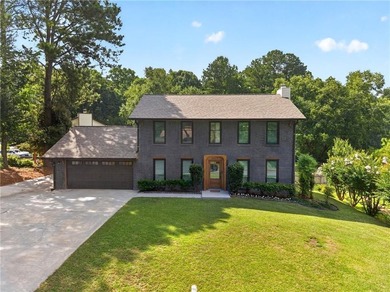 Tucked into a private wooded lot with a stunning lake view in - photo 5