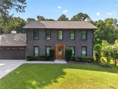 Tucked into a private wooded lot with a stunning lake view in - photo 6