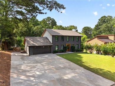 Tucked into a private wooded lot with a stunning lake view in - photo 7