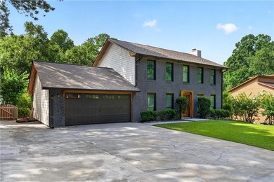 Tucked into a private wooded lot with a stunning lake view in - photo 8
