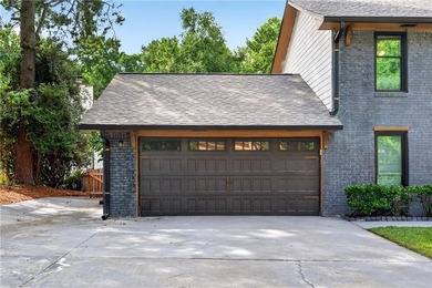 Tucked into a private wooded lot with a stunning lake view in - photo 9