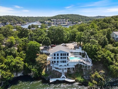 Perched above the shimmering waters of the Lake of the Ozarks - photo 1