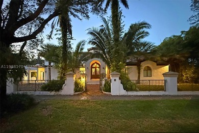 Set on one of Coral Gables finest tree-lined streets, this - photo 2