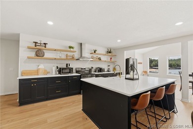 Lakefront living on 2 private acres at the 8MM near Laurie! - photo 1