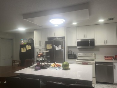 Beautiful home featuring a modern kitchen with white cabinets - photo 13