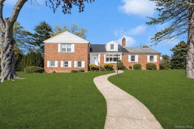 This Munsey Park brick split-level home is situated on a - photo 1