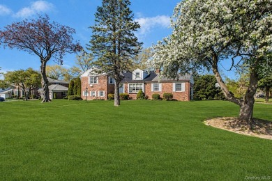 This Munsey Park brick split-level home is situated on a - photo 2