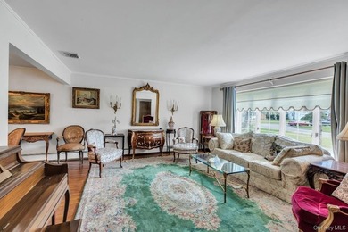 This Munsey Park brick split-level home is situated on a - photo 3
