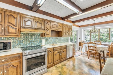 This Munsey Park brick split-level home is situated on a - photo 8