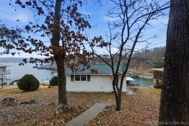 Discover this unique 2-bedroom, 1-bath lakefront cabin offering - photo 2