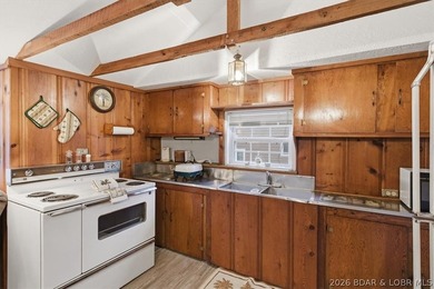Discover this unique 2-bedroom, 1-bath lakefront cabin offering - photo 8