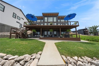 Contemporary luxury meets effortless lake living in this - photo 2