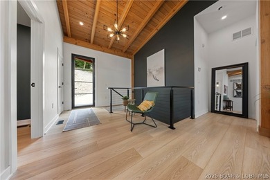 Contemporary luxury meets effortless lake living in this - photo 8
