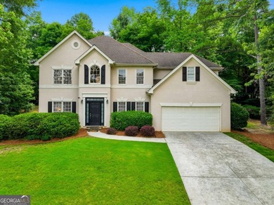 Nestled in the highly sought-after Waters Edge, this traditional - photo 1