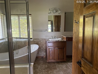 Set on 1.48 wooded acres along Lake Limestone, this custom stone - photo 16