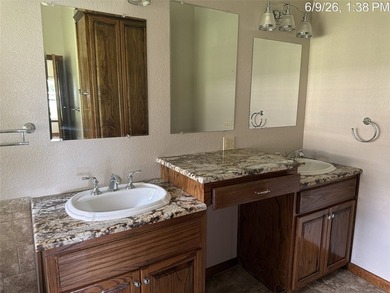 Set on 1.48 wooded acres along Lake Limestone, this custom stone - photo 17