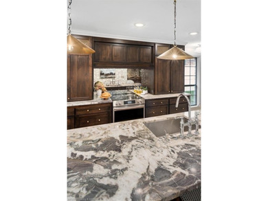 Stunningly renovated in 2024, this 4-bedroom, 3 full bath and 1 - photo 9