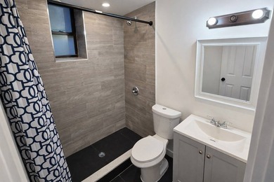 Introducing a fully renovated two-family residence situated on a - photo 8