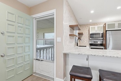 Welcome to this beautifully renovated corner-unit condo in the - photo 9