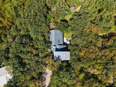 Nestled beneath a canopy of mature trees with sweeping views of - photo 2