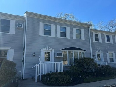 This inviting second-floor condo in Westhampton offers a - photo 1