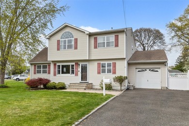 This beautifully renovated Colonial in East Islip sits on an - photo 1