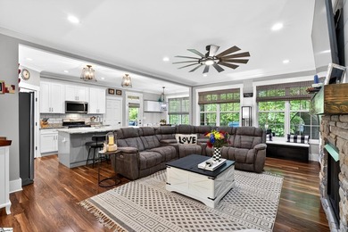 An oversized covered front porch with stained wood ceilings sets - photo 9