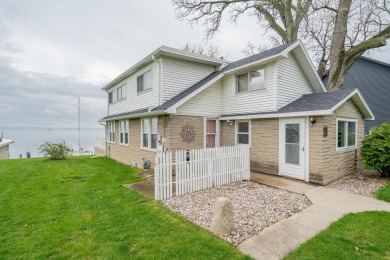 Nestled on the serene shores of Lake Butte Des Mort, this - Lake Home For Sale in Butte Des Morts, Wisconsin