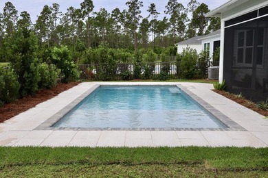 Check out the new pool deck & landscaping! Enjoy an amenity-rich - photo 47