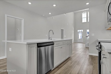 This spacious townhome boasts a first-floor primary suite, and - photo 32