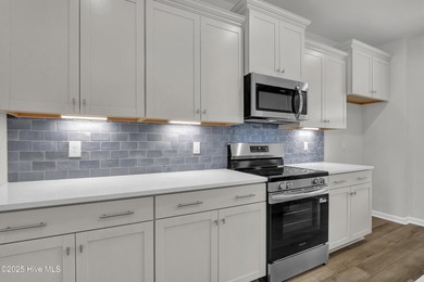 This spacious townhome boasts a first-floor primary suite, and - photo 33