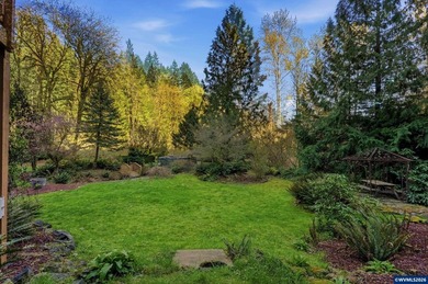 A custom chalet-style home surrounded by natural forest on - photo 16