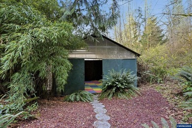 A custom chalet-style home surrounded by natural forest on - photo 18