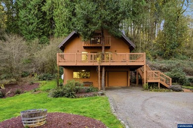 A custom chalet-style home surrounded by natural forest on - photo 20